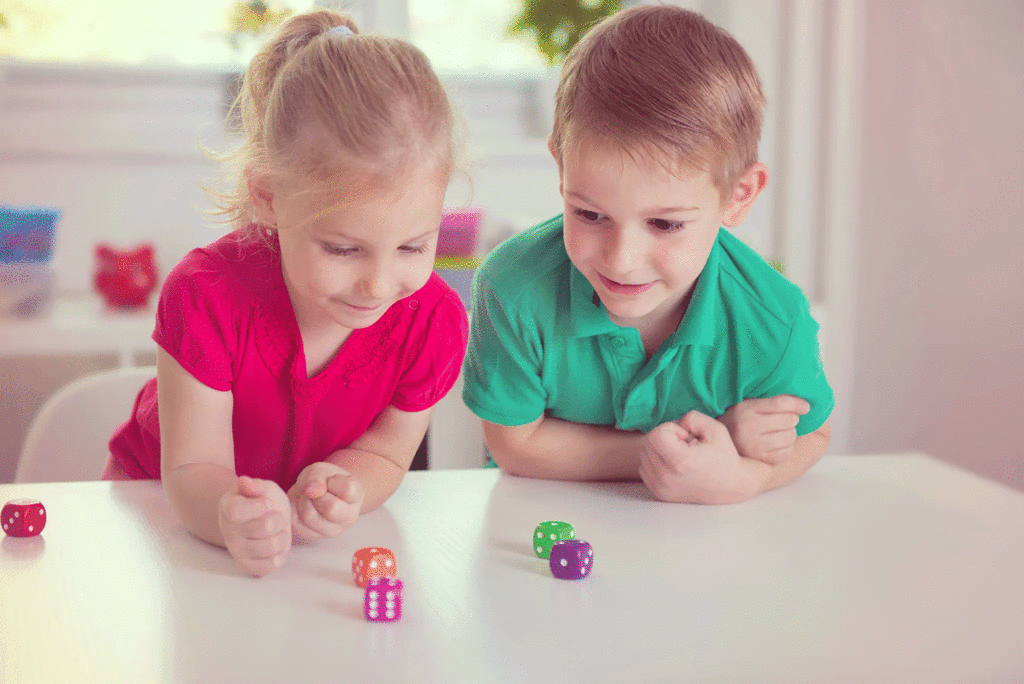 brother-and-sister-playing-with-dice-at-table