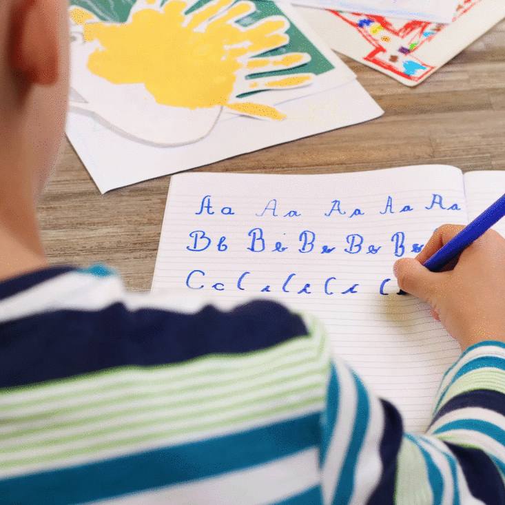 boy-over-shoulder-writing-cursive