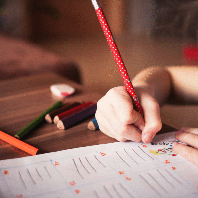 girl-writing-on-paper-at-desk2